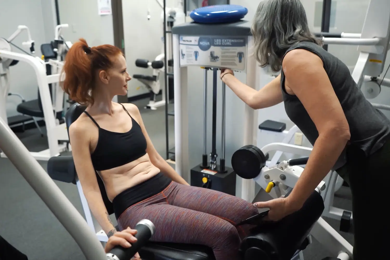 Personal trainer coaching a client in a Denver apartment gym