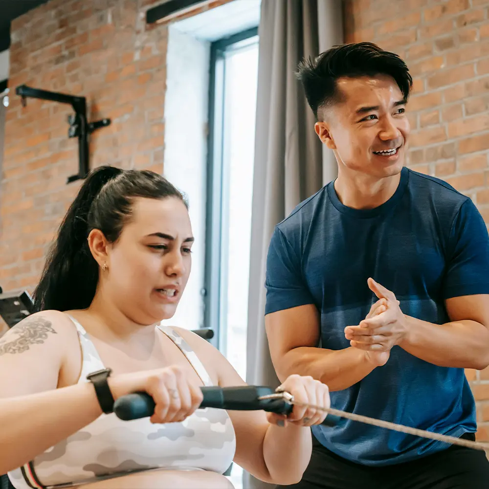 Personal trainer helping client lose weight in Denver